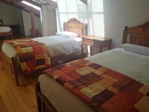Cama o camas de una habitación en Departamentos Cusco