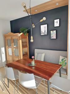 a dining room with a wooden table and white chairs at GOETHE49 - Herbstauszeit, private Sauna, Kamin, Ankommen und Wohlfühlen, viel Platz in gemütlicher und erholsamer Atmosphäre in Rielasingen-Worblingen