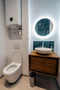 a bathroom with a sink and a toilet at Le clocher du château in Fontainebleau +2 photos