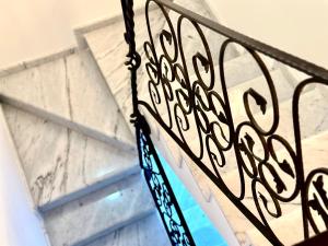 a close up of a metal railing in front of a building at Manor Pastrovici in Budva +18 photos