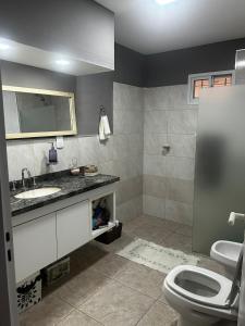 a bathroom with a sink and a toilet at Casa en villa amancay, villa general belgrano in Villa Amancay