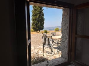 a view of a table and chairs through a window at Manor Pastrovici in Budva
