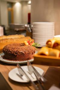 a chocolate cake on a table in a kitchen at Suntory Hotel in Pará de Minas