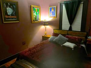 a bedroom with a bed and a lamp at Dr. Yaple's Art Deco House in Lafayette +10 photos
