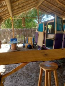 a van parked under a wooden roof with a stool at Portal Verde Barra Grande Piauí in Barra Grande