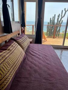 a bedroom with a bed with a view of the ocean at Cabana Alegria - Ocean View Home - 2 Master Suites in San Agustinillo +27 photos
