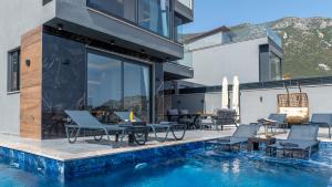 a house with a swimming pool next to a building at Villa cihan kalkan in Kas