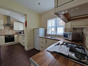 a kitchen with a sink and a stove top oven at Town centre, very convenient in Newcastle under Lyme
