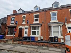 a brick building with trash cans in front of it at Town centre, very convenient in Newcastle under Lyme