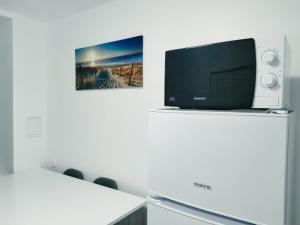 a television sitting on top of a refrigerator at La Suite Élégance in Obernai