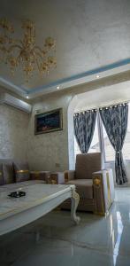 a living room with a couch and a chandelier at AR Luxury VIP Apartments Ravda in Ravda +96 photos