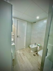 a white bathroom with a toilet and a sink at VVVHouse in Manilva +45 photos