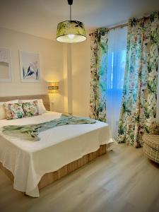 a bedroom with a bed and a large window at VVVHouse in Manilva