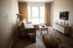 a living room with a couch and a window at Apartman Mila Subotica in Subotica