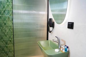 a bathroom with a green sink and a shower at Akpınar Marin Hotel in Çeşme +14 photos