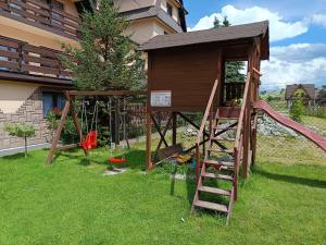 a play structure with a slide and a playground at Wynajem Pokoi Stachon in Poronin