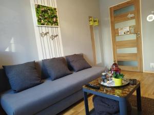a living room with a couch and a table at Niewielki pokój dla jednej osoby lub pary. in Warsaw +33 photos