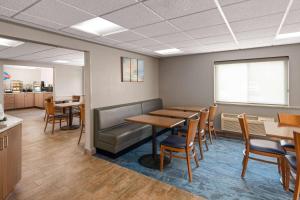 a waiting room with a table and chairs at Baymont by Wyndham Mt. Pleasant in Mount Pleasant
