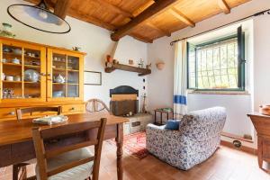 a dining room with a table and a chair at Apartment the Fireplace a relax oasis near Florence in Villore