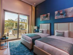 Postel nebo postele na pokoji v ubytování Rixos The Palm Hotel & Suites - Ultra All Inclusive