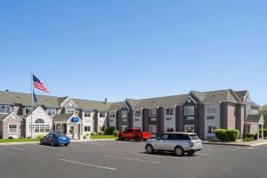 a parking lot with cars parked in front of a building at Baymont by Wyndham Boardman in Boardman