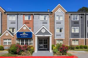 a large brick building with a hospital sign on it at Microtel Inn by Wyndham Raleigh-Durham Airport in Morrisville