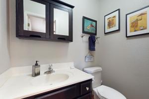 a bathroom with a sink and a toilet at The Forest Cottage in Payson +18 photos