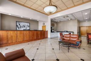 a waiting room with leather chairs and a waiting counter at Super 8 by Wyndham Longview/North in Longview