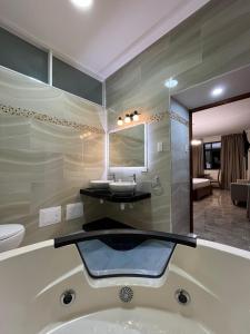 廷戈玛丽亚Caruzo Hotel and suites的带水槽和浴缸的浴室