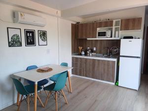 a kitchen and dining room with a table and chairs at La Demorada in Mercedes