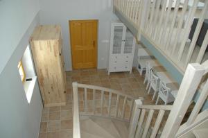 a hallway with stairs and a wooden door at Country house Martinova Klet in Prosenjakovci