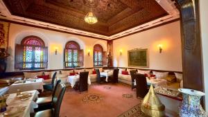a restaurant with tables and chairs in a room at Sillage Palace Sky & Spa in Marrakesh