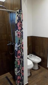 a bathroom with a toilet and a shower curtain at Casa Selva in Costa del Este