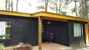 a house with a yellow roof and a patio at Casa Selva in Costa del Este +1 photo