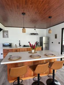 a kitchen with a large island with two bar stools at Alma Vida Lofts in Fortuna