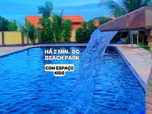 a water feature in a pool at a resort at Pousada Vila Italia - Porto da Dunas in Aquiraz