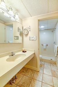 a bathroom with a sink and a toilet and a mirror at Town & Country Inn & Resort in Gorham