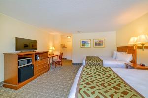 a hotel room with two beds and a television at Town & Country Inn & Resort in Gorham