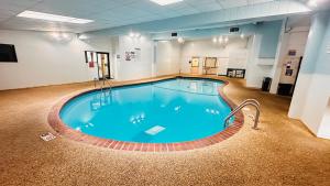 a large swimming pool in a gym with blue water at Quality Inn St Paul-Minneapolis-Midway in Saint Paul