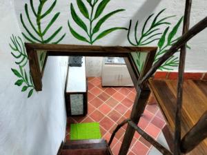 a room with a wall with plants painted on it at La Villa in Zapatoca +33 photos