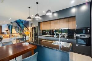a kitchen with a wooden counter top and a table at Grand Villa Sân Golf - Venuestay in Vĩnh Phúc