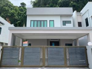 a house with a gate in front of it at Hillside House, Ipoh Garden, 9 pax, Hillview in Ipoh