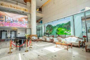 a room with couches and a ping pong table in a building at The Vissai Hotel in Ninh Binh