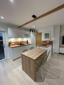 a kitchen with a large wooden table and chairs at Maison indépendante avec jardin in Orvault +1 photo