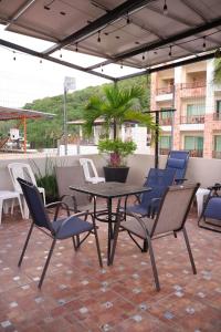 eine Terrasse mit einem Tisch und Stühlen auf einer Terrasse in der Unterkunft Bungalows Yeah Los Ayala in Los Ayala