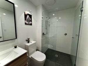 a bathroom with a shower and a toilet and a sink at Sydney Private Home in Bankstown +31 photos