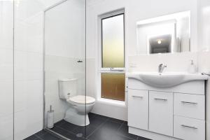 a white bathroom with a sink and a toilet at 91 On the Rocks 91 Port Elliot Rd Hayborough Chiton - No Linen Included in Hayborough +12 photos