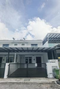 a large white house with a porch and stairs at Cosy 2-Storey Holiday Home Vines 2 @Pasar Malam -2 in Tanah Rata