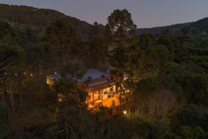 an aerial view of a house in the woods at night at Villa Vida Cabanas in São Joaquim