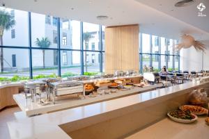 a buffet line in a building with food at Oceanview Apartment at Arena Cam Ranh Resort in Thôn Hòa Ða